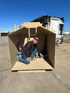 shelter-set250220-floort-knox-cutaway-ron-pointing-on-floor