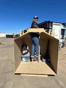 shelter-set250220-floort-knox-cutaway-ron-standing-on-stairs