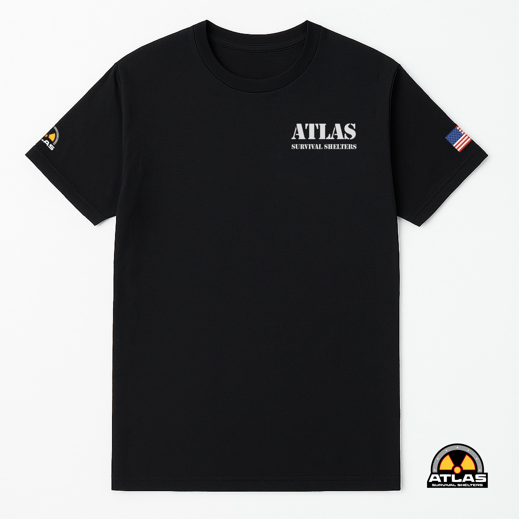 Black T-shirt showing the Atlas Survival Shelters logo on the chest, with an American flag patch on the right sleeve and a radium-style patch at the bottom-right corner.