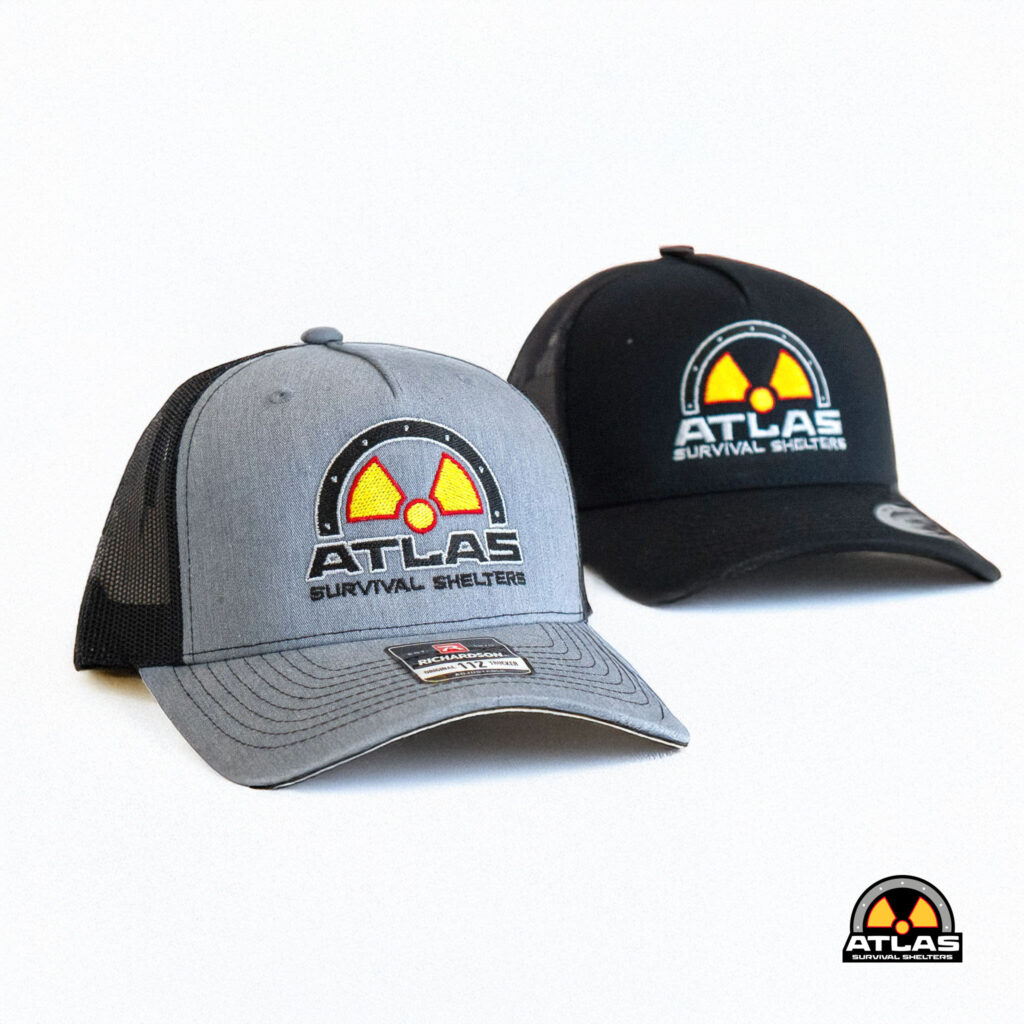 Gray trucker cap featuring a circular Atlas Survival Shelters logo with a yellow radiation symbol in the center
