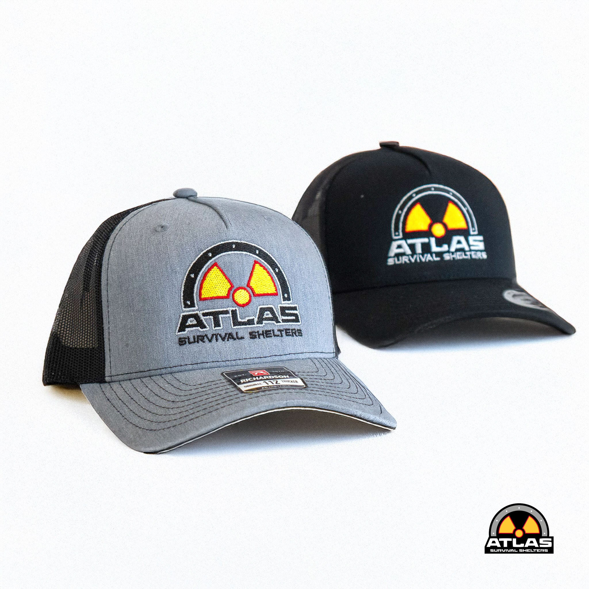 Gray trucker cap featuring a circular Atlas Survival Shelters logo with a yellow radiation symbol in the center