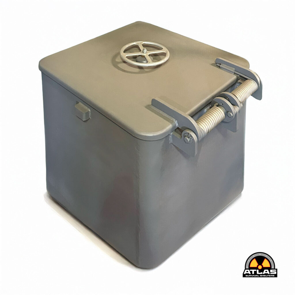 Gray metal safe with a circular wheel valve on the lid and an Atlas Survival Shelters logo in the lower-right corner.