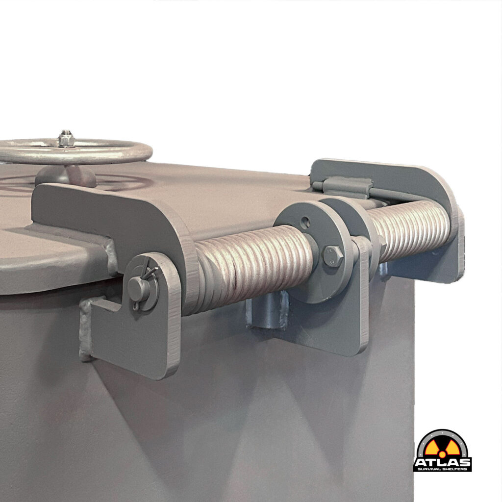 Close-up of industrial roller assembly with metal frame and shaft bolt; Atlas Survival Shelters logo at bottom-right.
