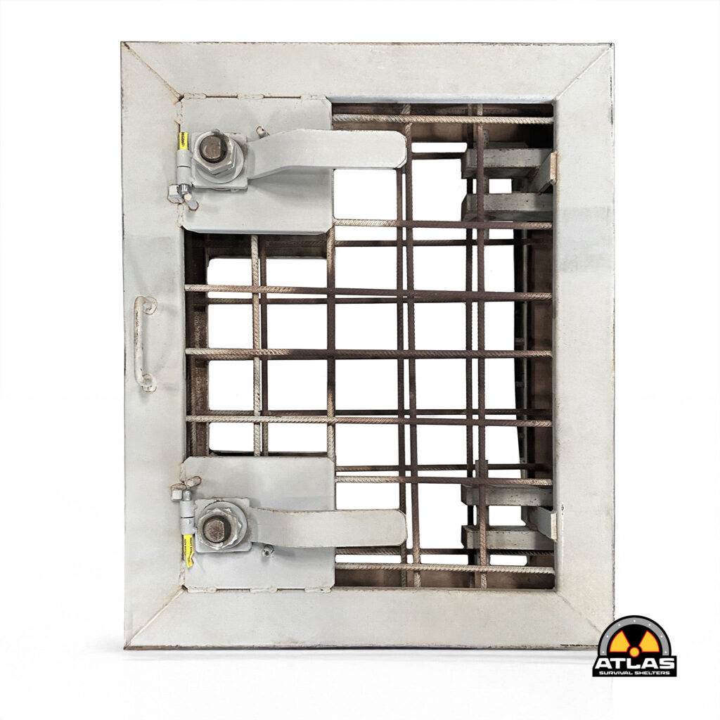 Close-up of a gray metal emergency shelter frame with a rusted grid interior and a yellow valve on the left, Atlas Survival Shelters logo visible bottom-right.