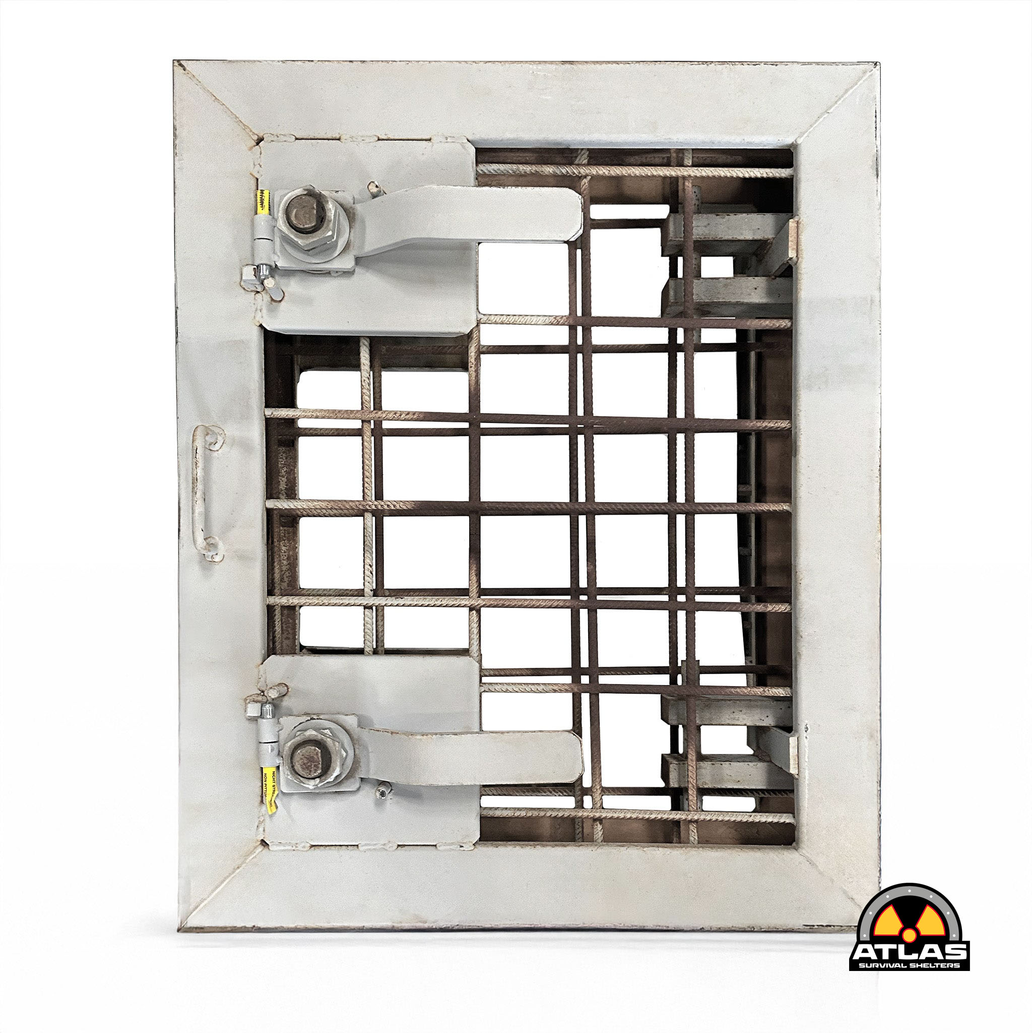 Close-up of a gray metal emergency shelter frame with a rusted grid interior and a yellow valve on the left, Atlas Survival Shelters logo visible bottom-right.