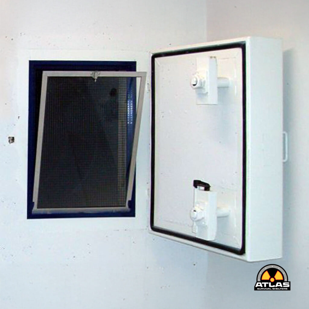 White wall with two metal safes: a large windowed cabinet on the left and a smaller locked box on the right, with a radiation warning logo in the bottom-right corner.