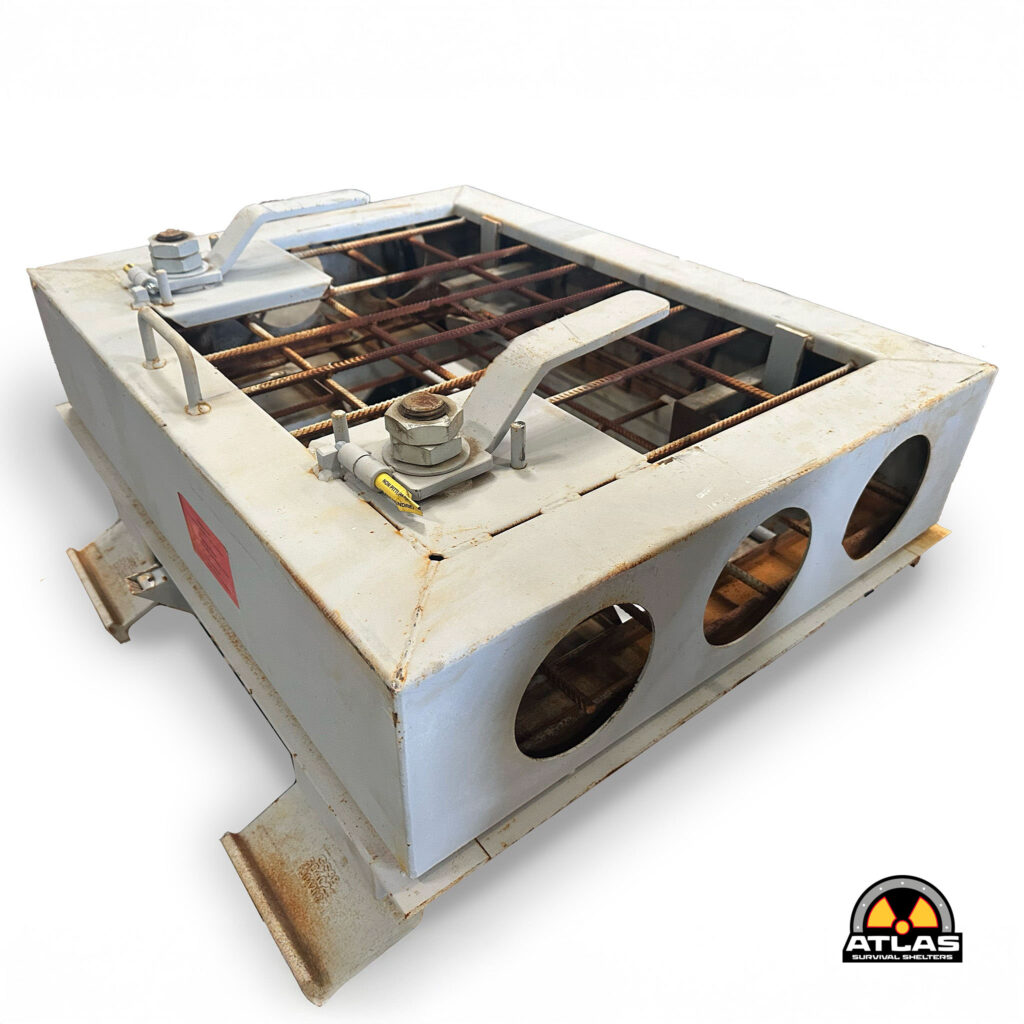Rusty metal fallout shelter unit with exposed rebar and a radioactive warning logo from Atlas Survival Shelters.