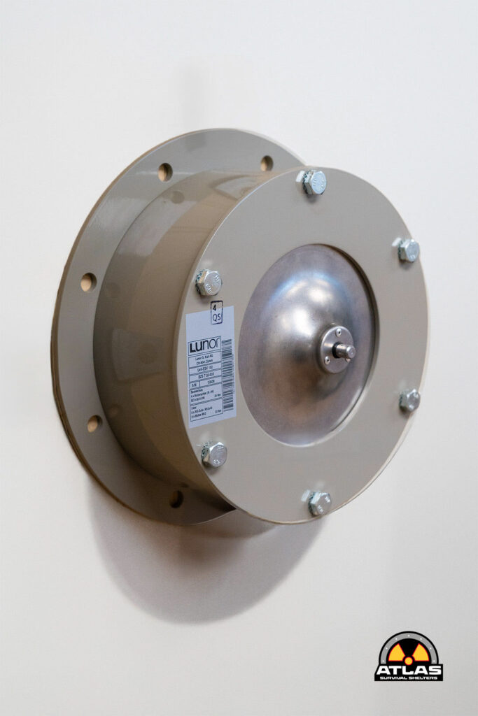 Circular metal flange bolted to a wall, with a central hub and Lunor label visible on the side.