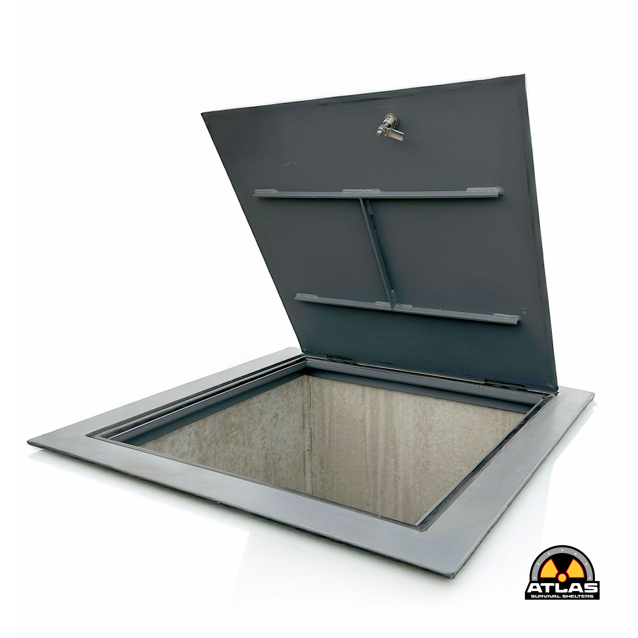 Close-up of a gray metal shelter roof with a small vent and a radiation symbol logo in the bottom-right corner.