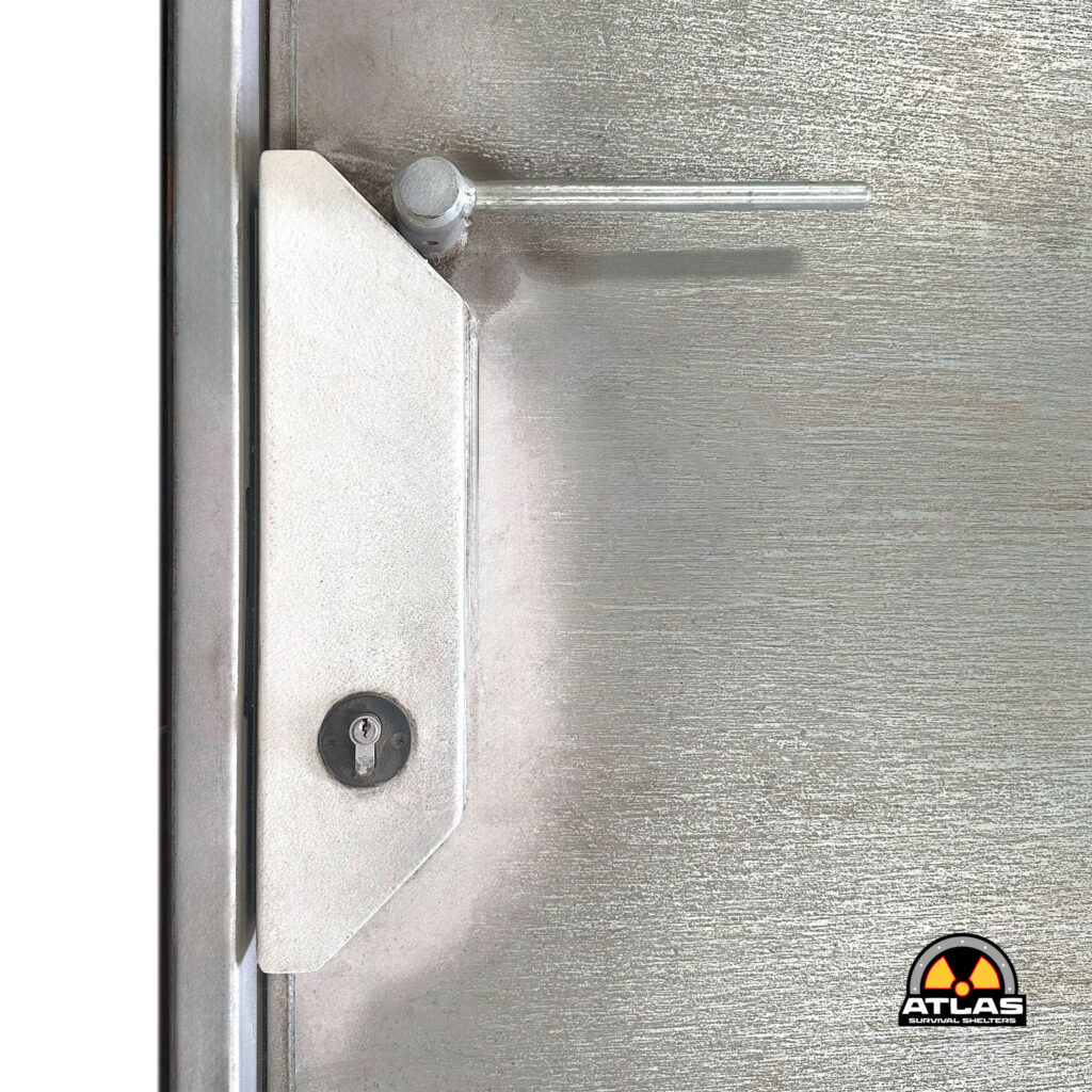 Close-up of a metal door edge with a round latch bolt; radiation warning logo for Atlas Survival Shelters visible in the bottom-right corner.