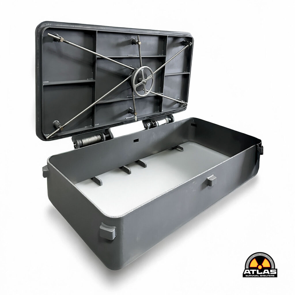 Open metal cabinet-like safe showing internal shelves, cross-braced rods, and a central wheel mechanism; Atlas Survival Shelters logo visible in corner.