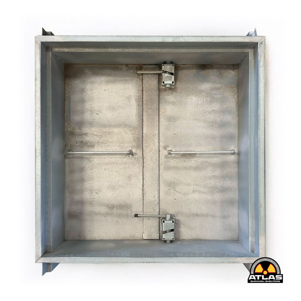 Open metal shelter with a gray, worn interior and a visible radiation hazard logo at the bottom right corner.