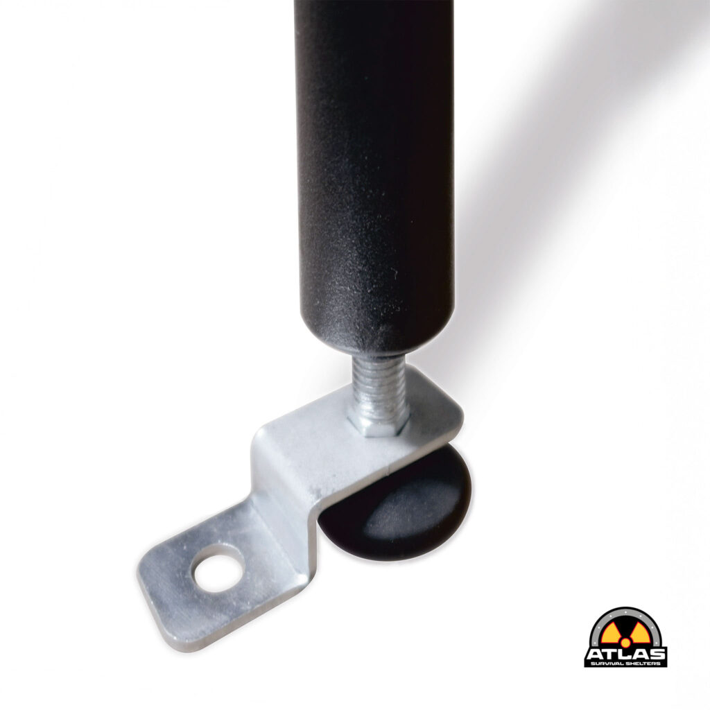Close-up of a black cylindrical rod with metal brackets and a round hole, showing hardware components and a partial Atlas Survival Shelters logo in the corner.